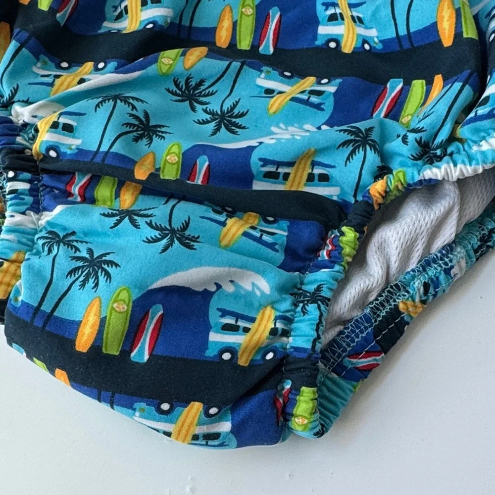 i play. Blue Surfboard and Palm Tree Swim Diaper
